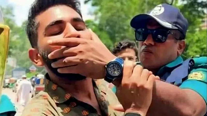 A police member is gagging a student protester